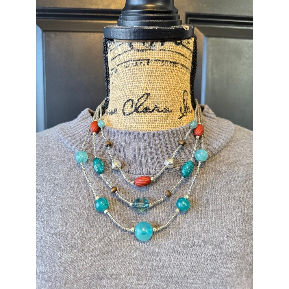 multi-strand beaded statement necklace featuring teal and red glass beads